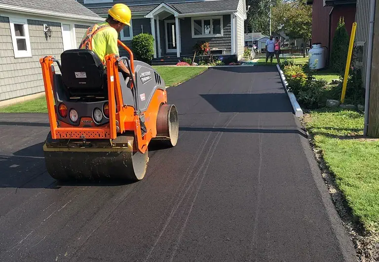 Homeowners watching the asphalt roller in Moncton